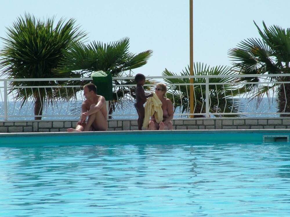 Photo of naturists in an outdoor pool - The worship of the naked body